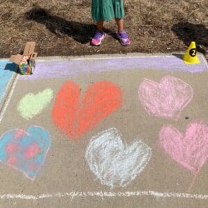 Different Color Heart Painting of a Child on Pavement