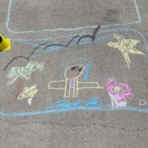 A Color Chalk Painting of a Kid on the Floor