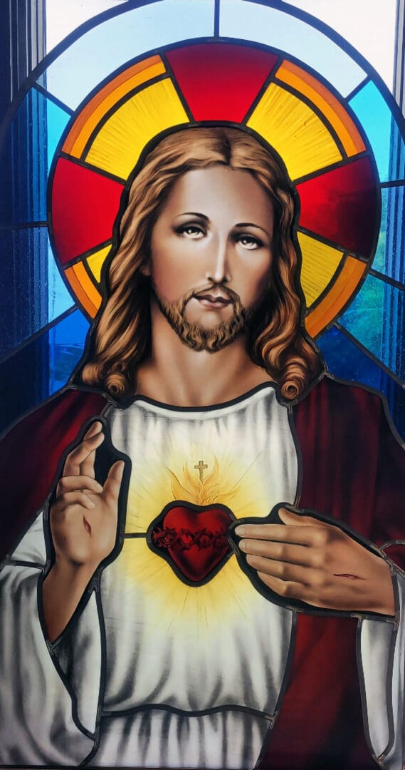 Stained glass window of Jesus with a bleeding heart.