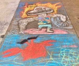 Chalk drawing of a surfer and crab.