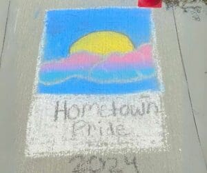 Chalk drawing of sunset with "Hometown Pride"