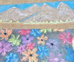 Chalk drawings of mountains and flowers.